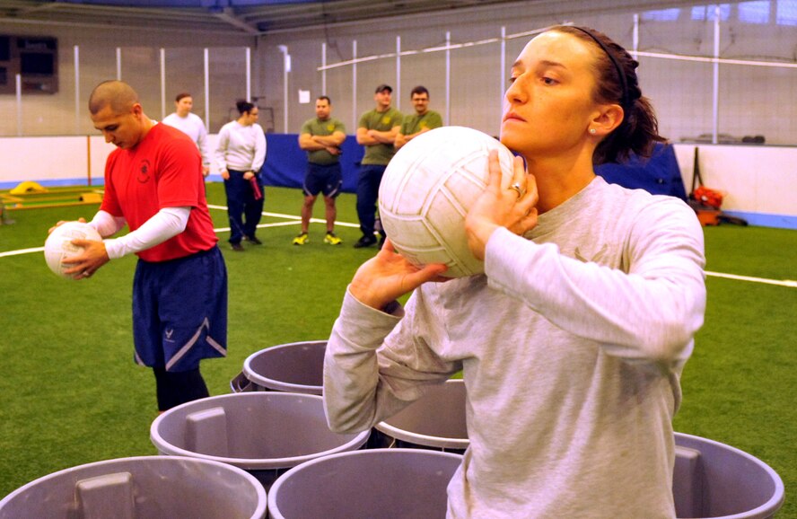 Senior Airman Tiffany Williams-Sequeira, 319th Civil Engineer Squadron, warms up for a game of Trash Can Pong during the 2015 Winter Bash event February 26 at the fitness center on Grand Forks Air Force Base, N.D. Winter Bash, as well as its counterpart, Summer Bash, is an annual event designed to boost morale and esprit de corps. (U.S. Air Force photo/Staff Sgt. Susan L. Davis)