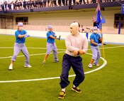 Members of the 319th Medical Group perform a dance routine during the pep rally portion of the 2015 Winter Bash opening ceremonies February 26 at the fitness center on Grand Forks Air Force Base, N.D. Winter Bash, as well as its counterpart, Summer Bash, is an annual event designed to boost morale and esprit de corps. (U.S. Air Force photo/Staff Sgt. Susan L. Davis)