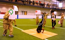 Members of the 319th Logistics Readiness Squadron perform a dance routine during the pep rally portion of the 2015 Winter Bash opening ceremonies February 26 at the fitness center on Grand Forks Air Force Base, N.D. Winter Bash, as well as its counterpart, Summer Bash, is an annual event designed to boost morale and esprit de corps. (U.S. Air Force photo/Staff Sgt. Susan L. Davis)