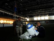 Senior Airman Brittney Shuff, 319th Force Support Squadron, and Chief Master Sgt. Kevin LaBrie, 319th Force Support Squadron chief enlisted manager, perform a skit during the pep rally portion of the 2015 Winter Bash opening ceremonies February 26 at the fitness center on Grand Forks Air Force Base, N.D. Winter Bash, as well as its counterpart, Summer Bash, is an annual event designed to boost morale and esprit de corps. (U.S. Air Force photo/Staff Sgt. Susan L. Davis)
