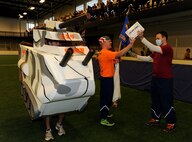 Members of the 319th Contracting Flight perform during the pep rally portion of the 2015 Winter Bash opening ceremonies February 26 at the fitness center on Grand Forks Air Force Base, N.D. Winter Bash, as well as its counterpart, Summer Bash, is an annual event designed to boost morale and esprit de corps. (U.S. Air Force photo/Staff Sgt. Susan L. Davis)