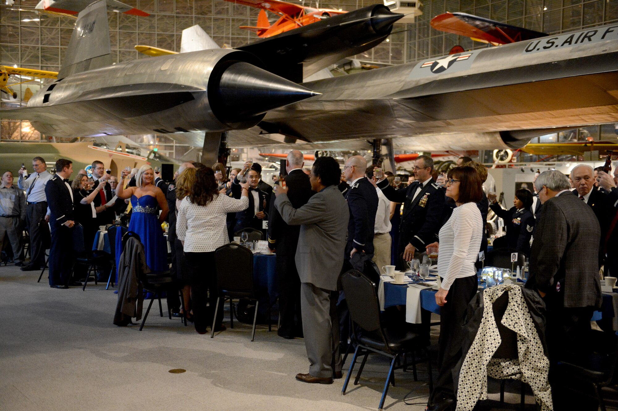 Attendants of the event hold up their glasses for a toast Feb. 19, 2015, during the 8th Airlift Squadron’s 75th anniversary at Boeing’s Museum of Flight Seattle, Wash. The event honored the history of the 8th AS and allowed members in the squadron an opportunity to get in touch with their roots. (U.S. Air Force photo/Airman 1st Class Keoni Chavarria)