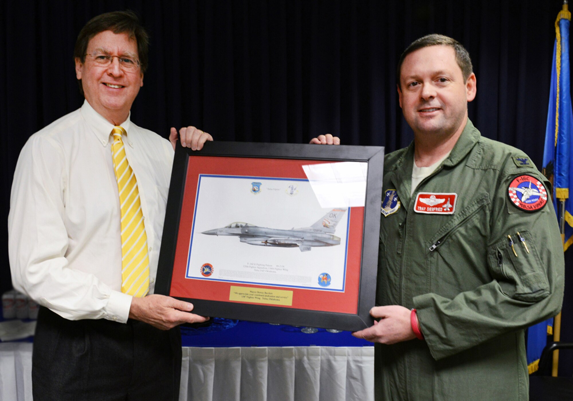 Col. Raymond Siegfried,  138th Fighter Wing vice commander presents a lithograph to Tulsa Mayor Dewey F. Bartlett, Jr. during a visit February 25, 2015 at the Tulsa Air National Guard base, Tulsa, Okla. The mayor was hosted by 138th leadership as a community outreach event aimed at fostering good relations and educating local leaders on the mission of the wing.