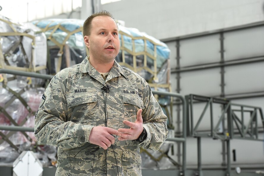 Senior Master Sgt. Kevin Massie, 76th Aerial Port Squadron (APS) superintendent, discusses a Denton airlift mission to Honduras with local media representatives Feb. 19, 2015. 76APS Airmen, known as the Port Dawgs, received shipments of the humanitarian cargo from Cleveland-based nonprofit MedWish International, organized it, weighed it and packed it onto 14 pallets. A KC-10 Extender tanker and cargo aircraft picked up the cargo Feb. 25 after inclement weather postponed the Feb. 19 mission. U.S. Air Force photo/Eric M. White