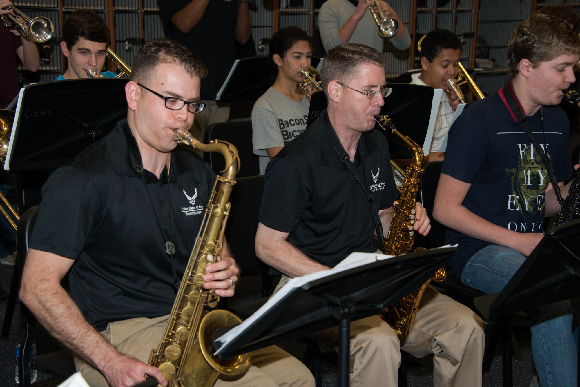 Tech. Sgt. Miles Hudlow, and Master. Sgt. Kenneth Drefke, members of the Air Force Band of the West ensemble, Dimensions in Blue, play the saxophone during a music clinic with the Ocean Springs High School Jazz Band in Ocean Springs, Miss. Feb. 23, 2015. The Air Force Band of the West has been touring and performing in several cities along the Gulf Coast.  (U.S. Air Force photo by Marie Floyd)