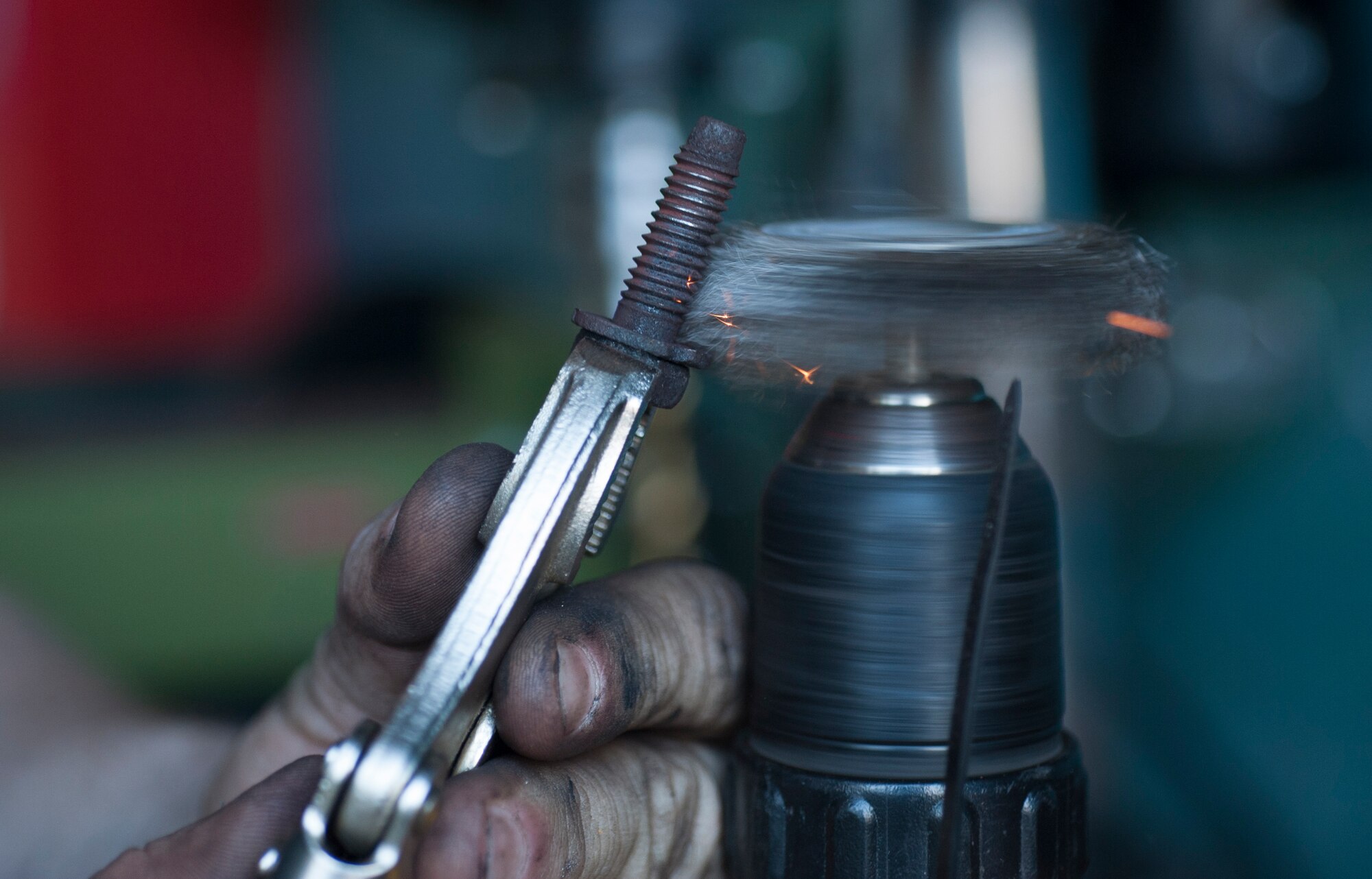 Airman 1st Class Sterling Dixon, a 314th Aircraft Maintenance Squadron engine troop, removes the rust from a manifold bolt Feb. 7, 2015, at his home in Cabot, Ark. Dixon removed the corrosion off a bolt to prevent it from ceasing up. (U.S. Air Force photo by Airman 1st Class Scott Poe)