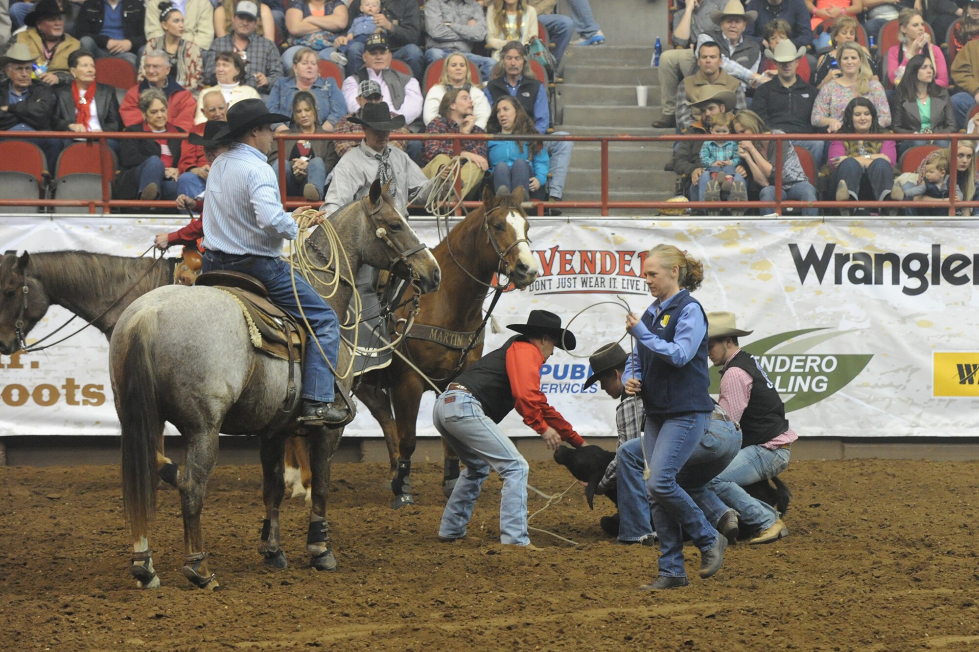 SAN ANGELO, Texas -- Col. Kimberlee P. Joos, 17th Training Wing Commander, prepares to hand the tie-down rope, or piggin' string, back to Dennis Luetge, San Angelo Stock Show and Rodeo competitor, during the 83rd Annual San Angelo Stock Show and Rodeo Military Appreciation Night at the Foster Communications Coliseum Feb. 25. The rodeo honored military members with special presentations during the night. (U.S. Air Force photo/ Staff Sgt. Laura R. McFarlane)