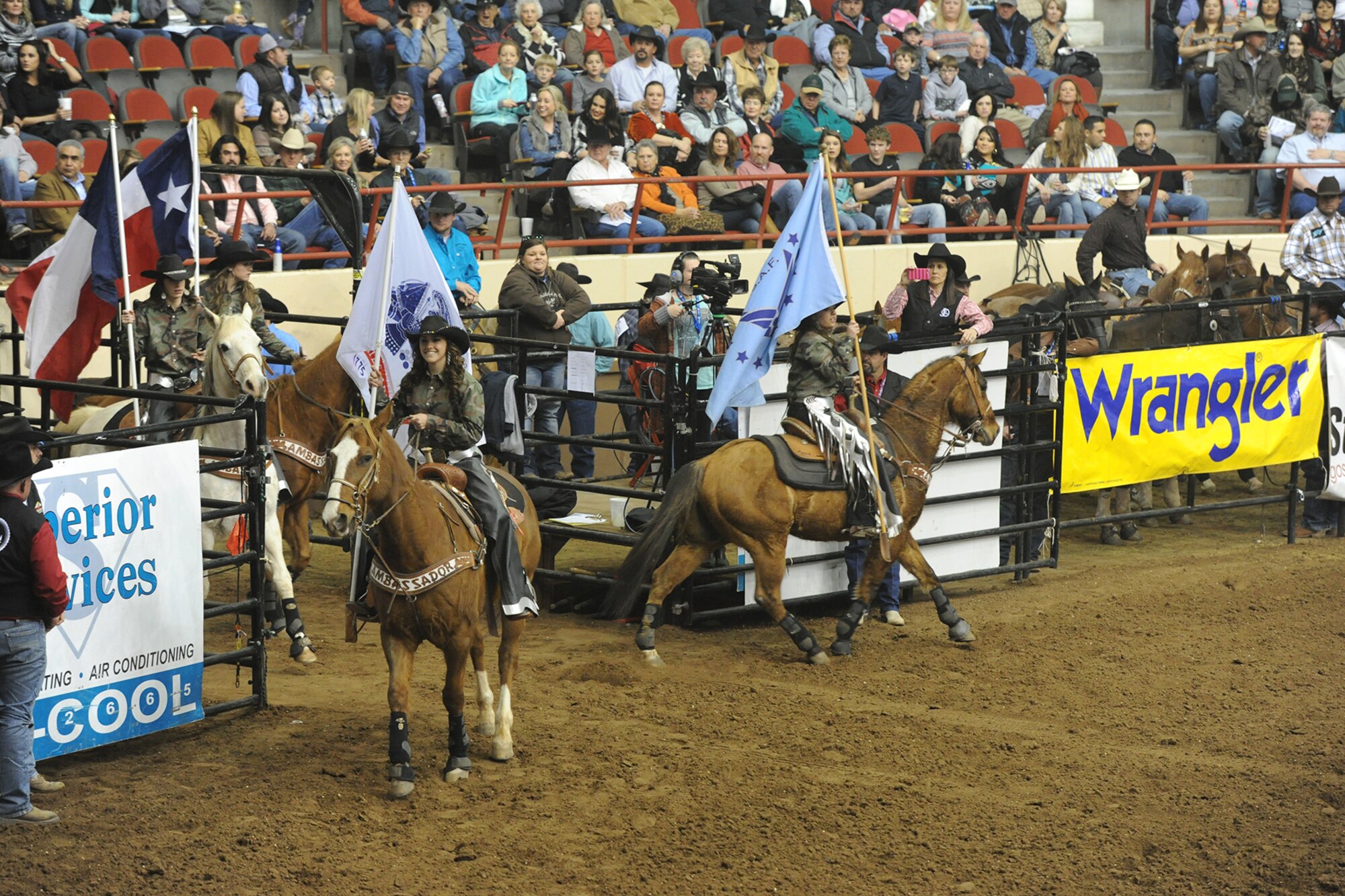 SAN ANGELO, Texas -- The San Angelo Ambassadors perform a drill routine during the 83rd Annual San Angelo Stock Show and Rodeo Military Appreciation Night at the Foster Communications Coliseum Feb. 25. The Ambassadors wore camouflage shirts and carried patriotic flags during the drill. (U.S. Air Force photo/ Staff Sgt. Laura R. McFarlane) 