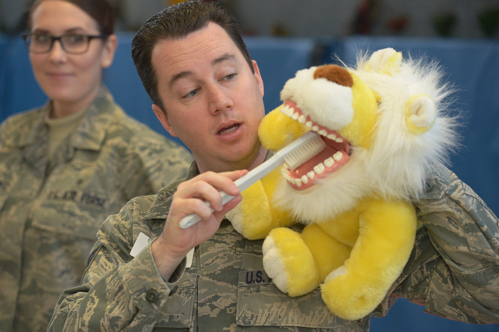 Tech. Sgt. Elijah Stewart, 66th Medical Squadron dental technician, demonstrates the proper way to brush your teeth to students at the Hanscom Primary School, Feb. 25. February is National Children’s Dental Health Month and programs such as the one presented at the Hanscom Primary School are designed to help children take care of their teeth. (U.S. Air Force photo by Jerry Saslav)