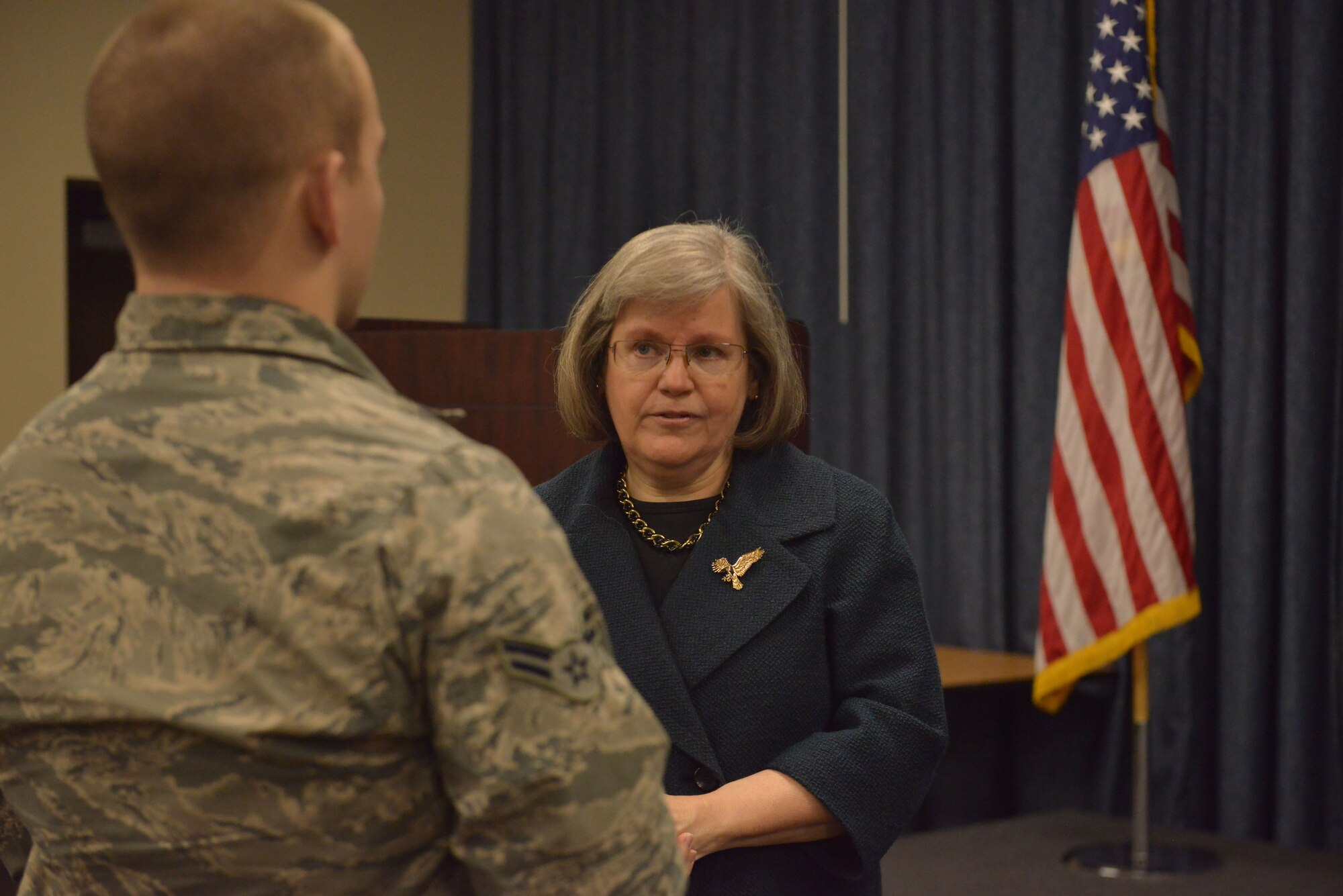 Holly Petraeus, the Assistant Director for the Office of Service member Affairs for the Consumer Financial Protection Bureau, speaks with an airman Feb. 23, 2015, at Fairchild Air Force Base, Wash. Petraeus visited the base to speak to military members and families about how they can improve their financial situations. (U.S. Air Force photo/ Staff Sgt. Alexandre Montes)