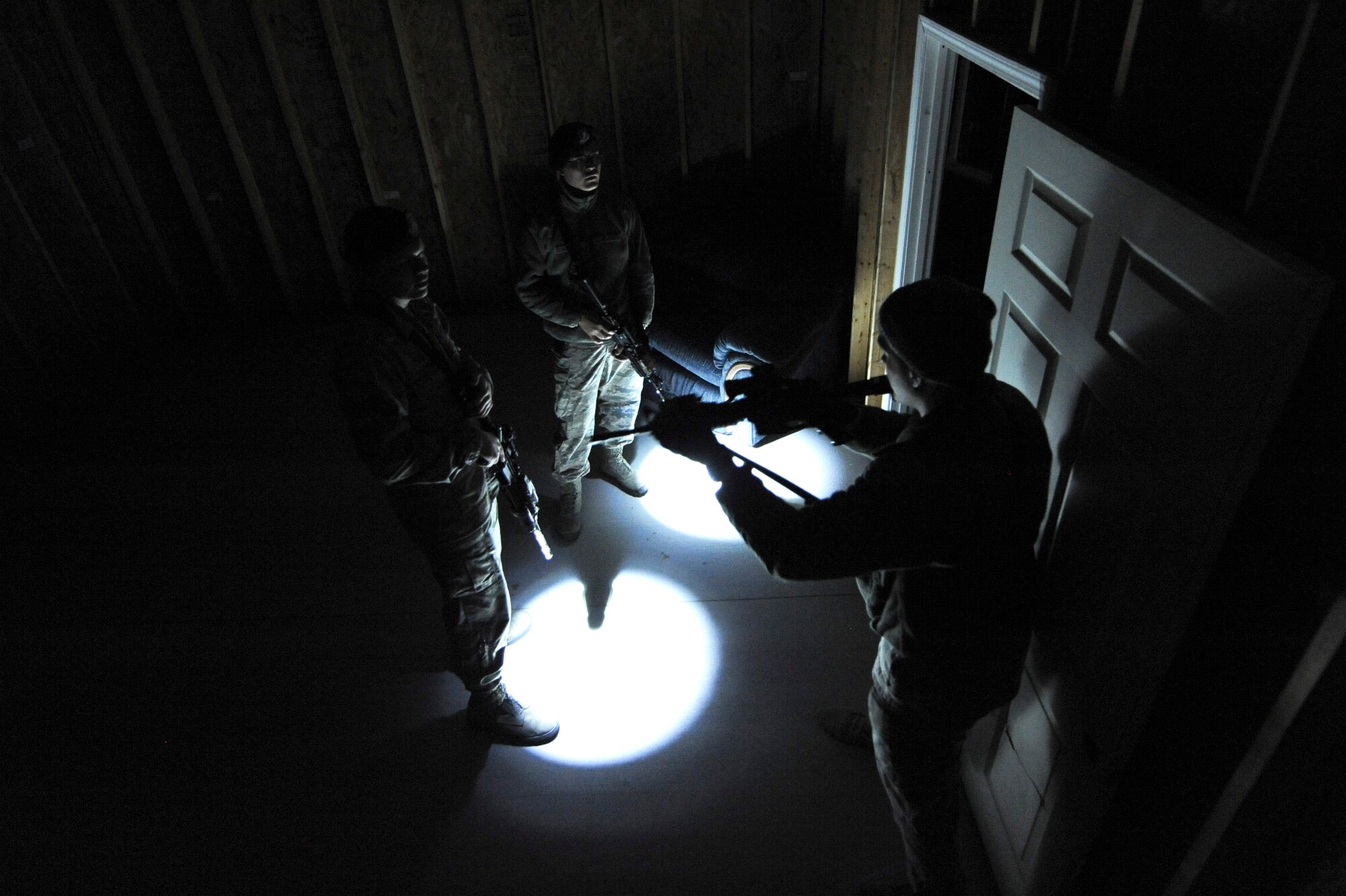Airmen assigned to the 4th Security Forces Squadron learn building clearing techniques during monthly training Feb. 11, 2015, at the range training complex on Seymour Johnson Air Force Base, North Carolina. Plans are currently underway to construct a classroom and install 36 closed-circuit cameras throughout the facility allowing instructors to better evaluate and debrief their Airmen. (U.S. Air Force photo/Airman 1st Class Aaron J. Jenne)
