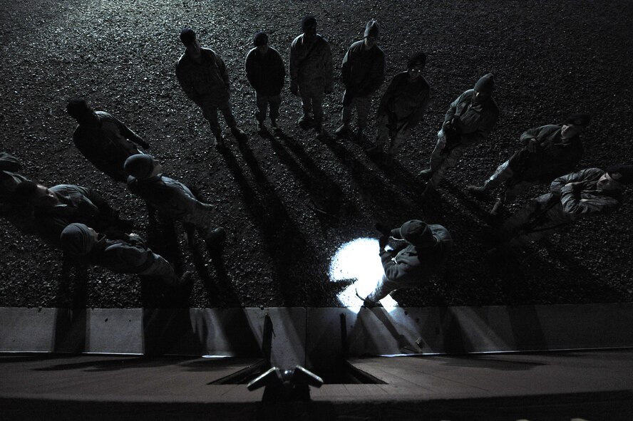 Airmen assigned to the 4th Security Forces Squadron receive instruction before breaching and clearing a building during monthly training Feb. 11, 2015, at the range training complex on Seymour Johnson Air Force Base, North Carolina. The facilities offer a realistic environment for 4th SFS patrolmen and 4th Civil Engineer Squadron explosive ordnance disposal members to train. (U.S. Air Force photo/Airman 1st Class Aaron J. Jenne)