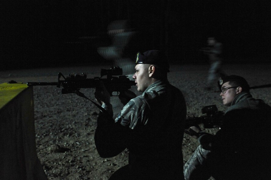 Airman 1st Class Michael Stoner (left) and Senior Airman Andrew Quarrella, 4th Security Forces Squadron patrolmen, provide cover for advancing defenders during a monthly training session Feb. 11, 2015, at the range training complex on Seymour Johnson Air Force Base, North Carolina. The squadron pioneered the first fully functional range training complex in Air Combat Command. (U.S. Air Force photo/Airman 1st Class Aaron J. Jenne)
