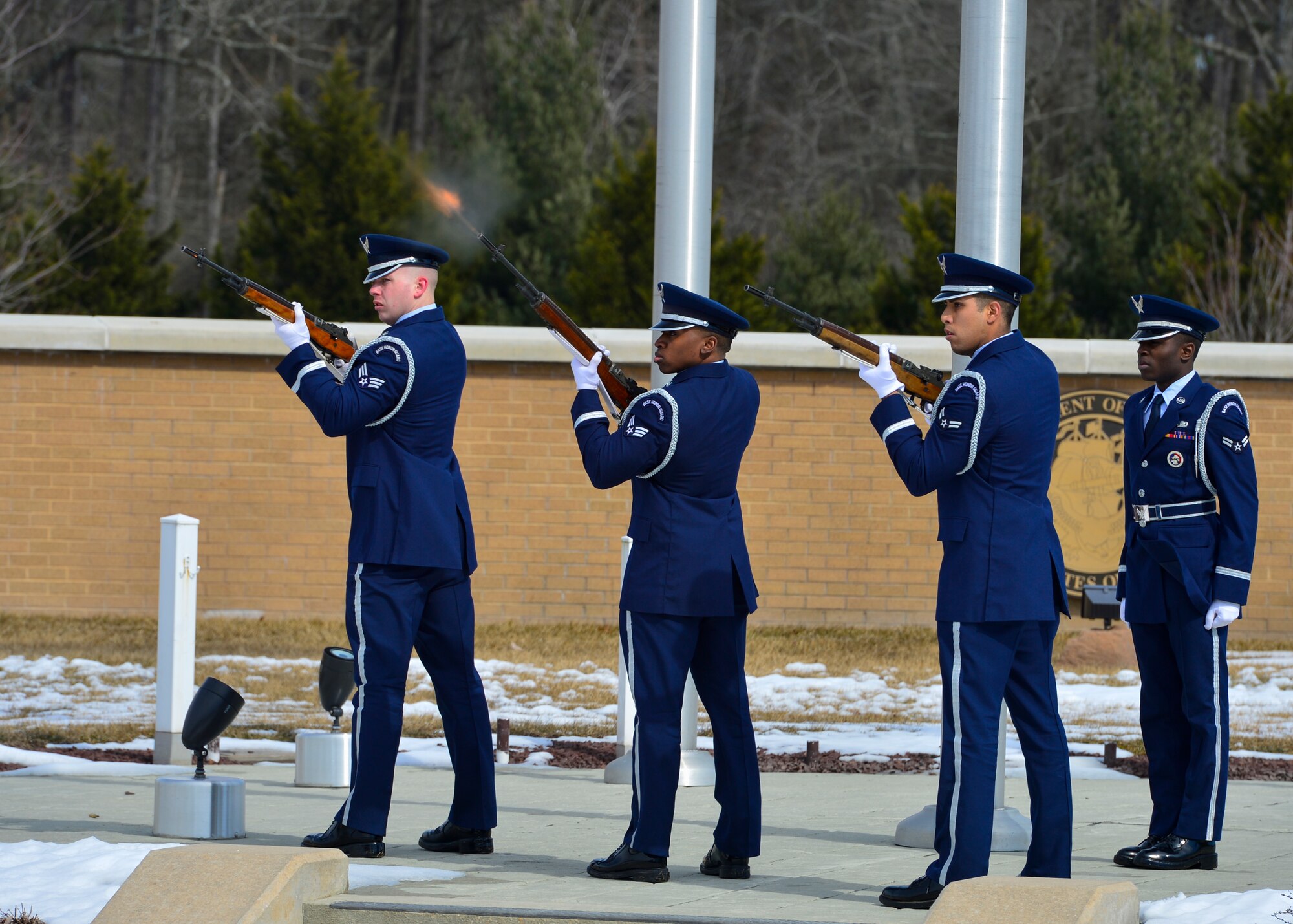 Airman 1st Class Derrick Harris orders Senior Airman James Korte, Senior Airman Tavin Alford and Airman 1st Class Jesus Cervantes-Martinez to fire three volleys during a funeral Feb. 25, 2015, at the Delaware Veterans Memorial Cemetery in Millsboro, Del. The firing party fired a total of nine shots to honor Jay Unterkofler, a U.S. Air Force retired master sergeant and a City of Dover Police retired sergeant. (U.S. Air Force photo/Airman 1st Class Zachary Cacicia)