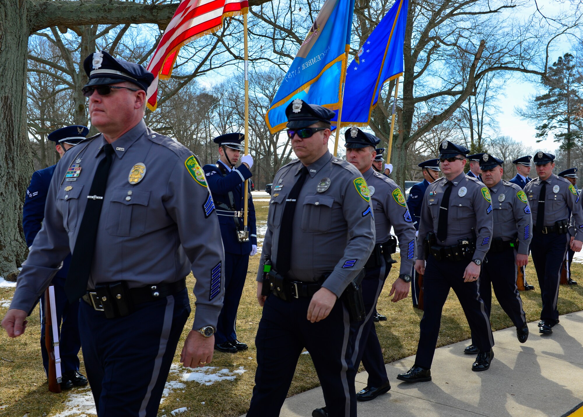 City of Dover Police officers walk past the Dover Air Force Base Honor Guard on their way to the funeral of Jay Unterkofler, a U.S. Air Force retired master sergeant and a City of Dover Police retired sergeant, Feb. 25, 2015, at the Delaware Veterans Memorial Cemetery in Millsboro, Del. Police officers from several Delaware police departments attended the funeral. (U.S. Air Force photo/Airman 1st Class Zachary Cacicia)