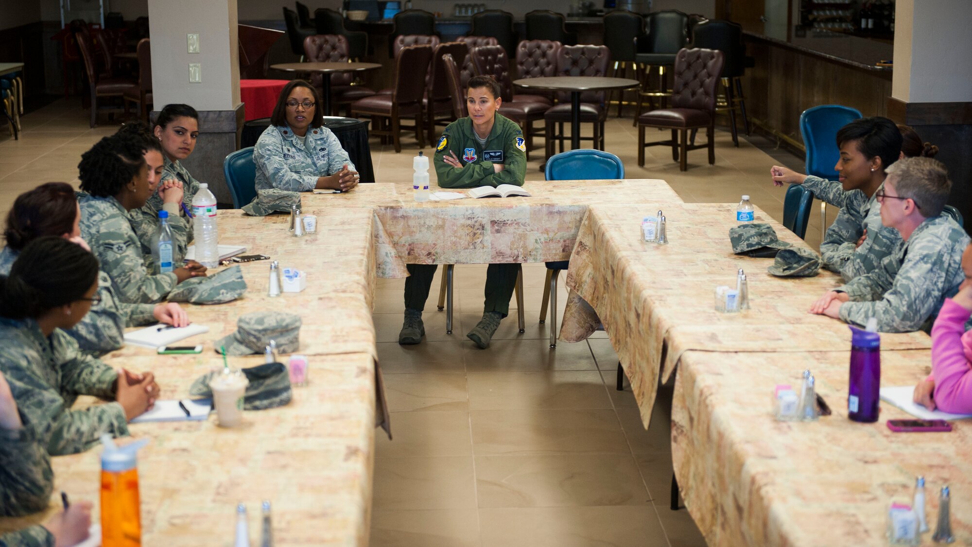 Sisters in Service leaders and participants discuss topics from the book “Hardball for Women” during a meeting at Club Holloman, Holloman Air Force Base, N.M. Feb. 17. SIS is a mentoring program geared toward women that focuses on topics such as leadership, mentorship and success in the workplace. (U.S. Air Force photo by Airman 1st Class Emily A. Kenney/Released)