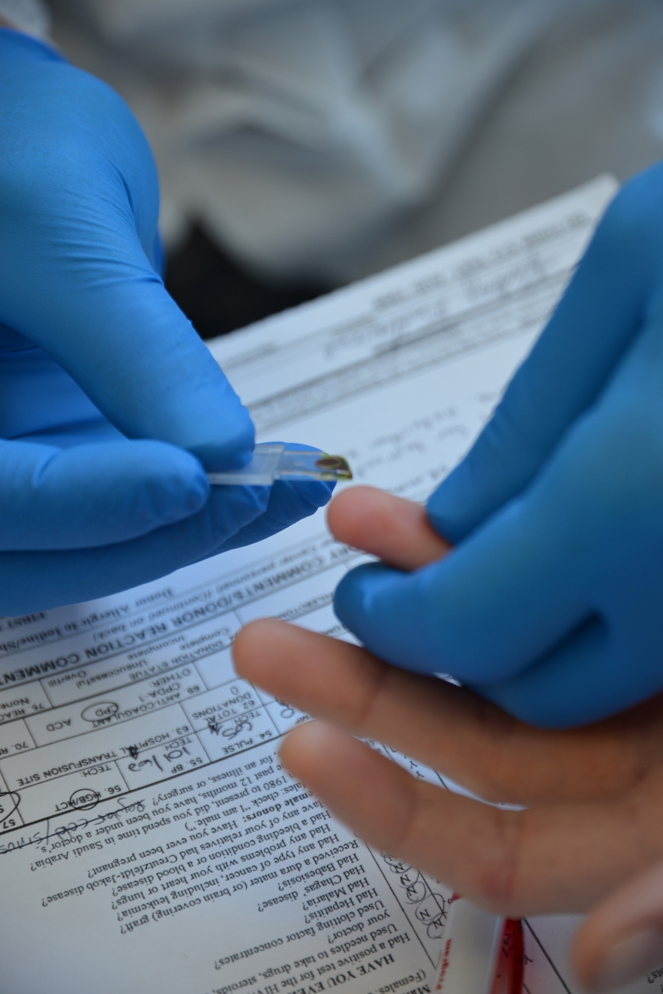 U.S. Air Force Capt. Jason Jacobsen, 48th Medical Group chief of clinical laboratory from Tacoma, Wash., performs initial vitals on a blood donor volunteer at a blood drive Feb. 25, 2015, on RAF Mildenhall, England. Laboratory technicians from the Armed Services Blood Program at Landstuhl Regional Medical Center, Germany, visited RAF Mildenhall and RAF Lakenheath to collect blood donations from service members, family members, retirees and Department of Defense civilians. The blood collected is specifically given to other U.S. service members and veterans. (U.S. Air Force photo by Karen Abeyasekere/Released)