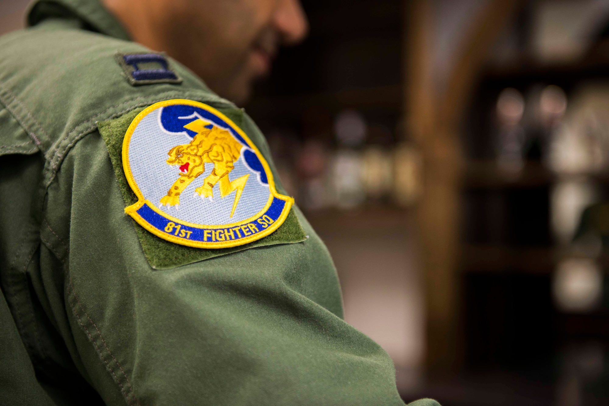An 81st Fighter Squadron patch rests on an Afghan air force pilot’s shoulder Feb. 24, 2015, at Moody Air Force Base, Ga. Over four years, the 81st FS will train 30 Afghan pilots and 90 Afghan maintainers as part of its Afghan air force flying and maintenance training mission. (U.S. Air Force photo by Airman 1st Class Dillian Bamman/Released)