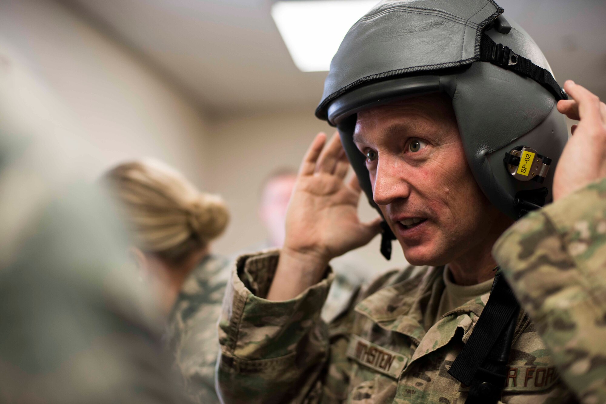 U.S. Air Force Brig. Gen. Michael Rothstein, Train, Advise, Assist Command Air (TAAC-AIR) commanding general, tries on a flight helmet at the 81st Fighter Squadron Feb. 23, 2015, at Moody Air Force Base, Ga.  The TAAC-AIR mission is to train, advise and assist Afghan partners in developing a professional, capable and sustainable Afghan air force. (U.S. Air Force photo by Airman 1st Class Dillian Bamman/Released)