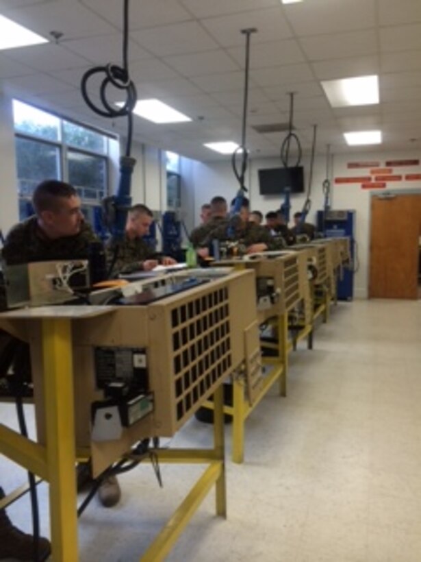 Marines in BRACT 2-15 conduct practical application in troubleshooting the small refrigeration system.