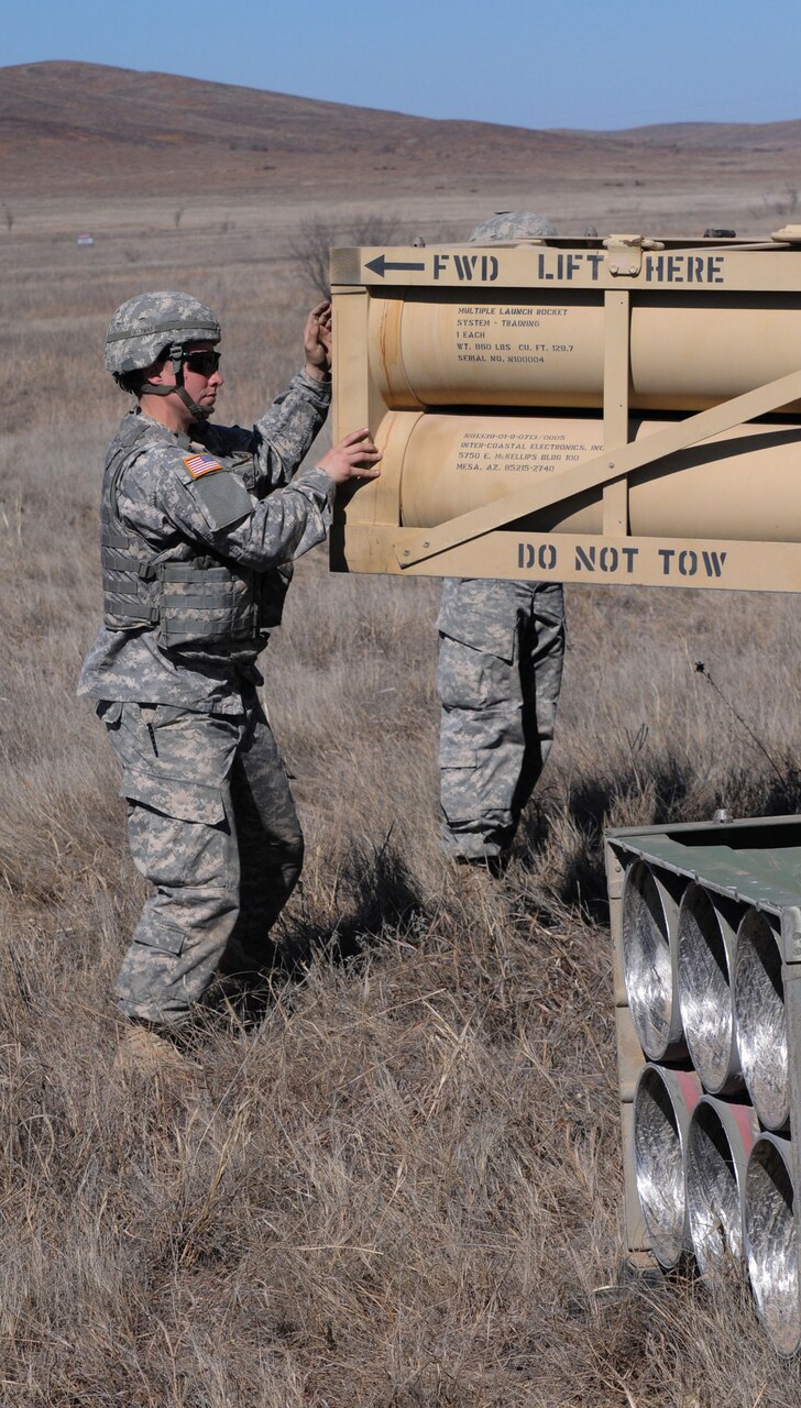 Army Cpl. Erica Gunter, a launcher chief in A Battery, 2nd Battalion, 4th Field Artillery at Fort Sill, Okla., works with her launcher crew to reload its M270A Multiple Launch Rocket System during recent certification exercises. U.S. Army photo by Sgt. Joe Dees