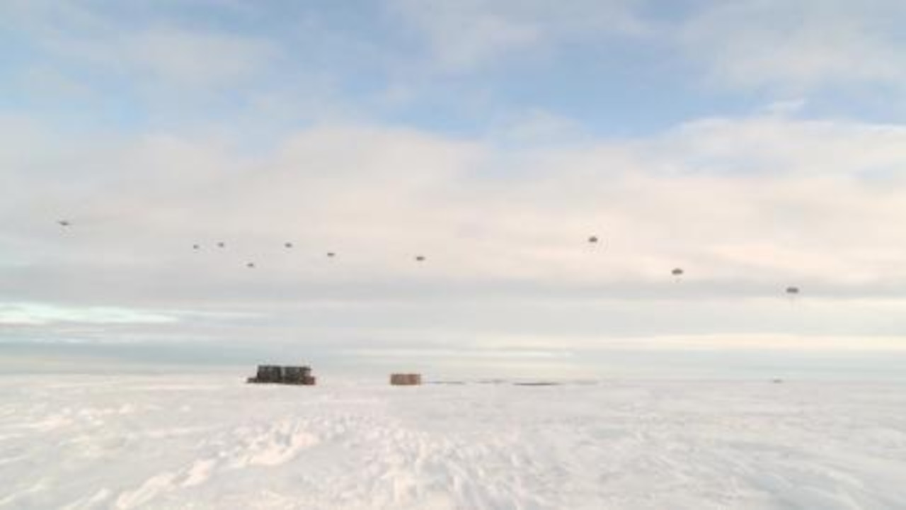 Personnel and cargo are airborne heading earthward during the Army’s Spartan Pegasus exercise in Deadhorse, Alaska, Feb. 24, 2015. U.S. Army photo