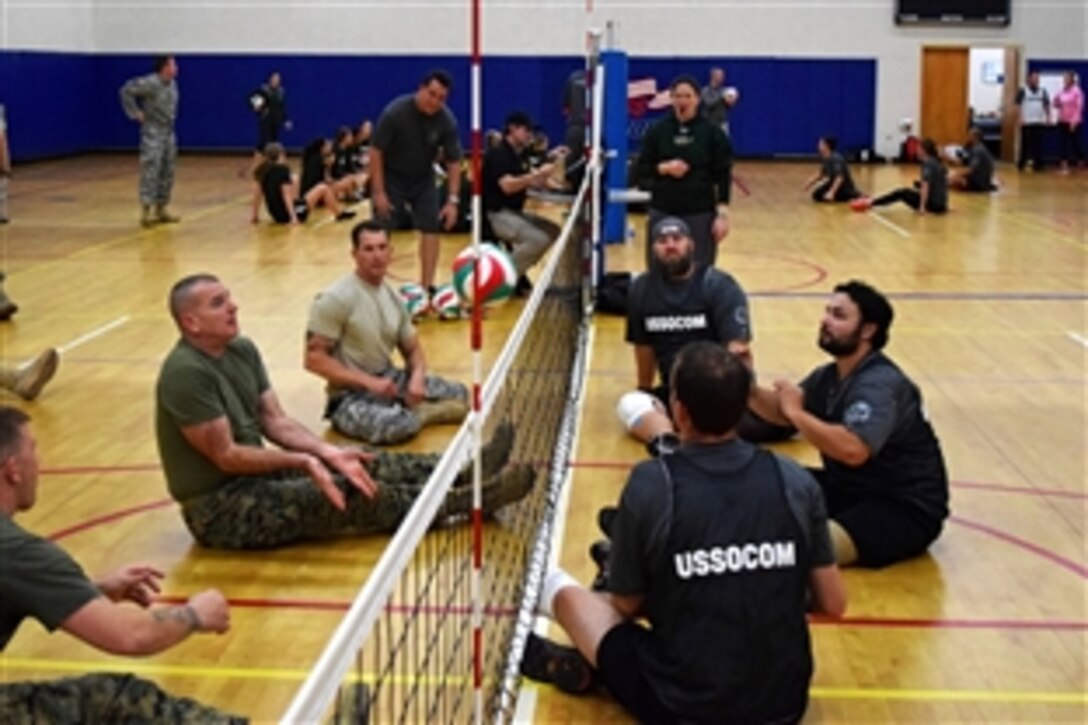 Marine Corps Sgt. Maj. Bryan Battaglia, center left, senior enlisted advisor to the chairman of the Joint Chiefs of Staff, hits a volleyball during a match between senior leaders and a U.S. Special Operations Command wounded warrior team on MacDill Air Force Base, Fla., Feb. 24, 2015.