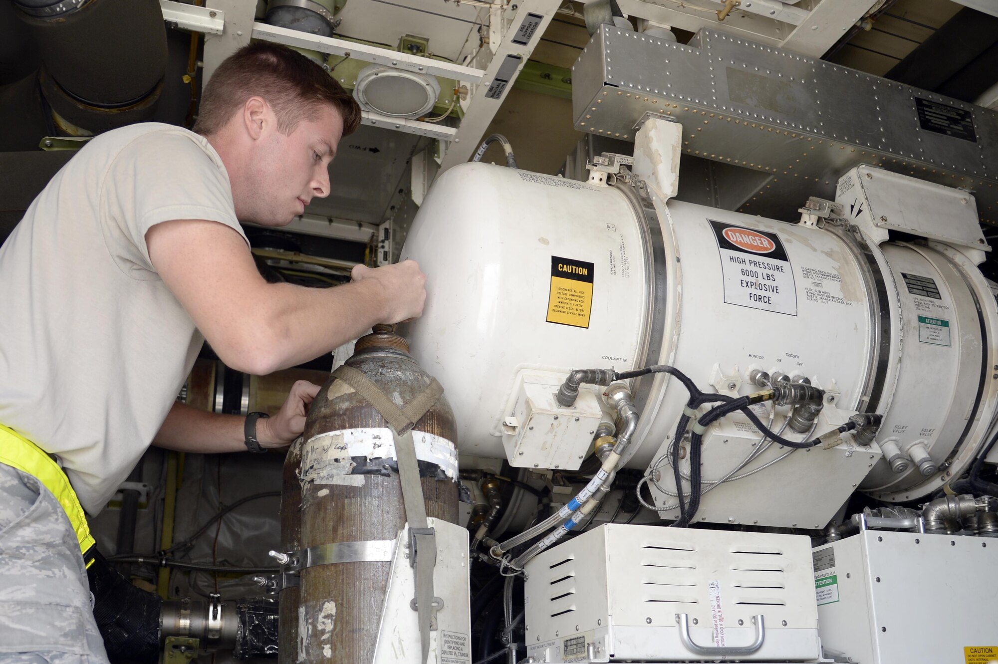 Senior Airman Travis, surveillance and radar technician, ensures the connections to the dielectric gas bottles are secure and there are no leaks during a preflight inspection on an E-3 Sentry airborne warning and control system aircraft at an undisclosed location in Southwest Asia Feb. 24, 2015. Sentry Aircraft Maintenance Unit Airmen provide command and control battle management to the combatant commanders here in the area of responsibility. Travis is currently deployed from Tinker AFB, Okla., and is a native of Snohomish, Wash. (U.S. Air Force photo/Tech. Sgt. Marie Brown)