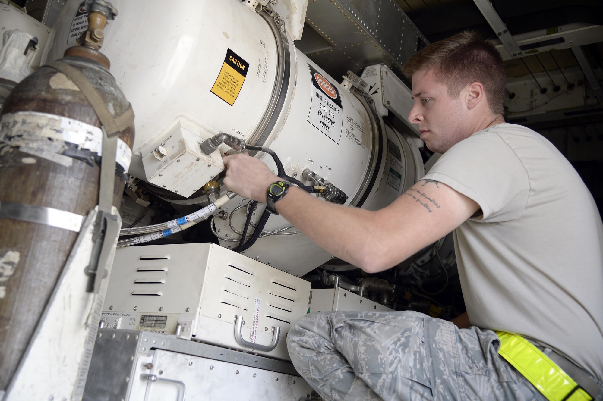 Senior Airman Travis, surveillance and radar technician, ensures the connections to the power amplifier are secure while performing a preflight inspection on an E-3 Sentry airborne warning and control system aircraft at an undisclosed location in Southwest Asia Feb. 24, 2015. The primary mission for surveillance and radar technicians is to make sure the aircrews have reliable radar in the air so they can command and control aircraft. Travis is currently deployed from Tinker AFB, Okla., and is a native of Snohomish, Wash. (U.S. Air Force photo/Tech. Sgt. Marie Brown)