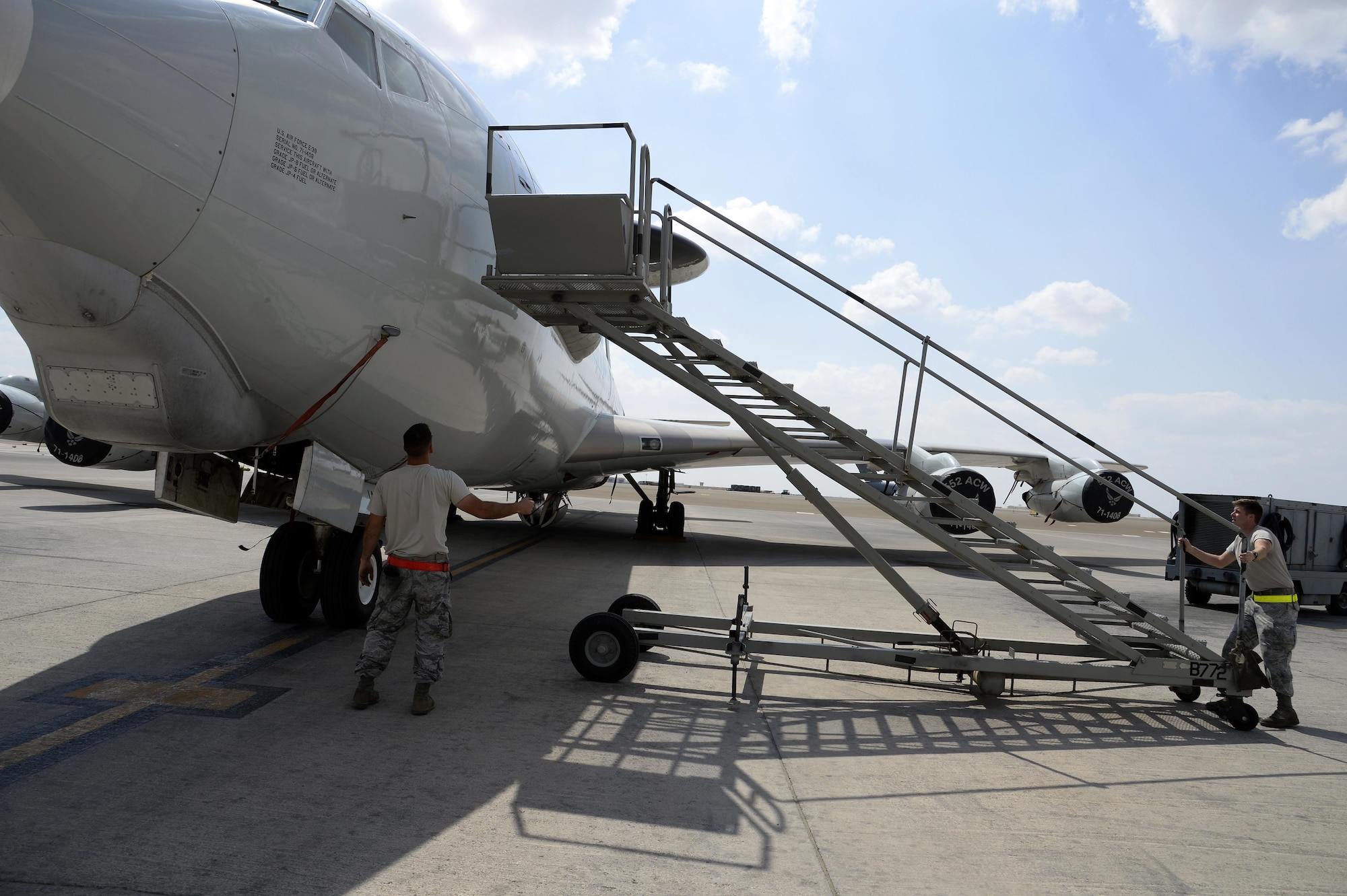 Staff Sgt. Derek, left, aerospace propulsion craftsman, and Senior Airman Travis, surveillance and radar technician, push a stand up to an E-3 Sentry airborne warning and control system aircraft at an undisclosed location in Southwest Asia Feb. 24, 2015. Since the beginning of Operation Inherent Resolve, Sentry has controlled 21,625 coalition aircraft and 1,122 kinetic effects, which can be anything from planned airstrikes to requests for close air support. Derek is currently deployed from Tinker Air Force Base, Okla., and is a native of Waterboro, Maine. Travis is currently deployed from Tinker AFB, Okla., and is a native of Snohomish, Wash. (U.S. Air Force photo/Tech. Sgt. Marie Brown)
