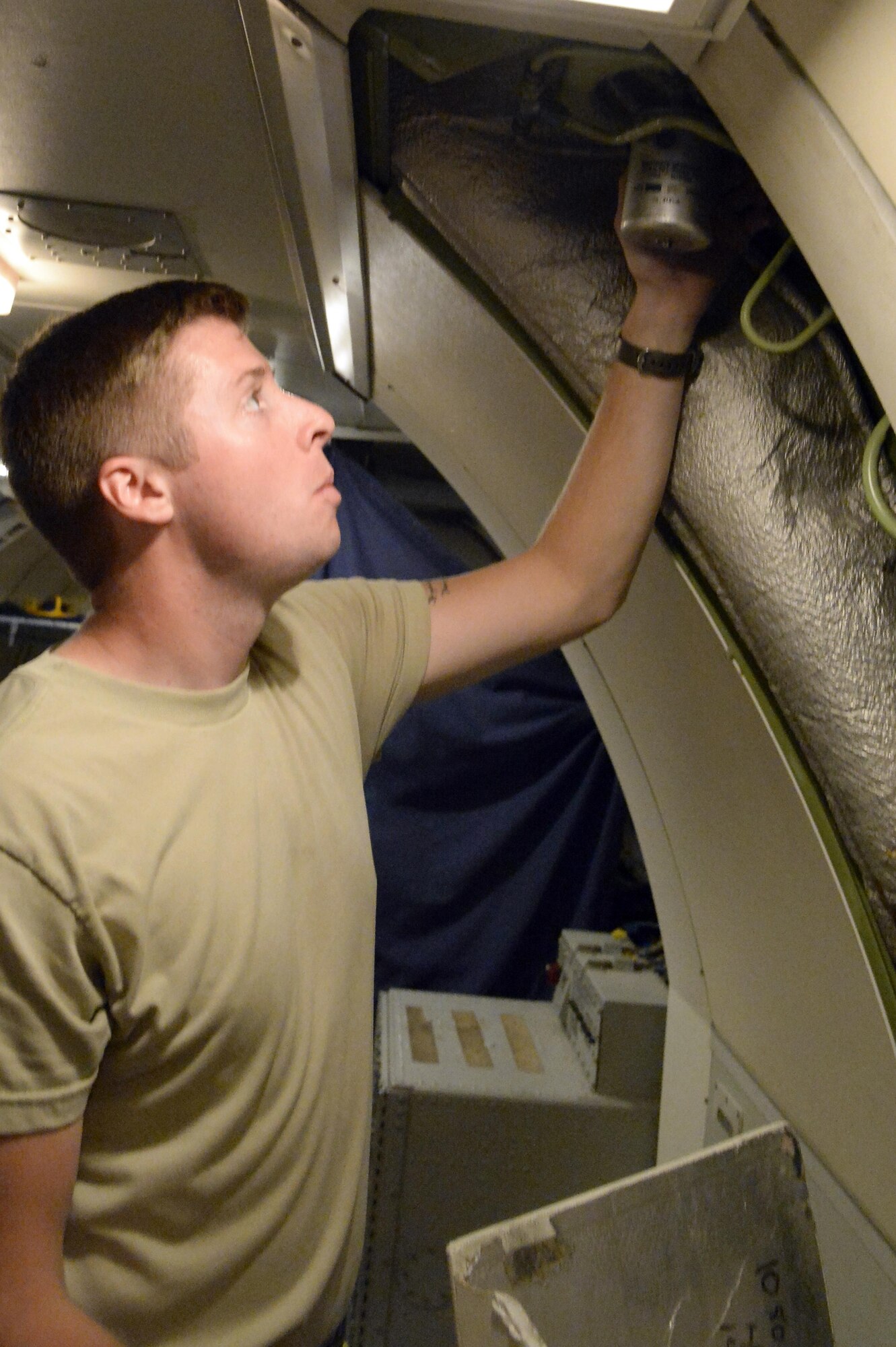 Senior Airman Travis, surveillance radar technician, performs a preflight inspection of the surveillance radar system on an E-3 Sentry airborne warning and control system aircraft at an undisclosed location in Southwest Asia Feb. 24, 2015. Since the beginning of Operation Inherent Resolve Sentry has controlled 21,625 coalition aircraft and 1,122 kinetic effects, which can be anything from planned airstrikes to requests for close air support. Travis is currently deployed from Tinker AFB, Okla., and is a native of Snohomish, Wash. (U.S. Air Force photo/Tech. Sgt. Marie Brown)