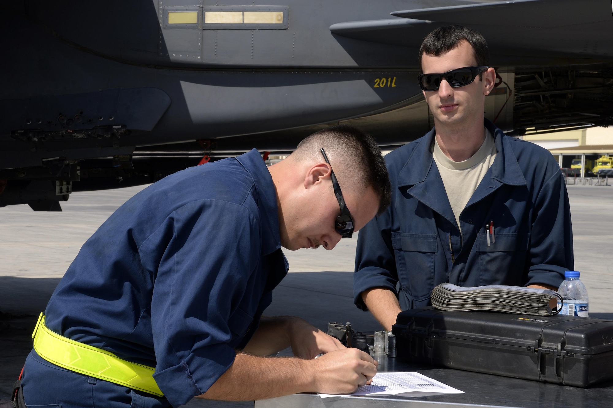 Staff Sgt. Matthew, left, and Staff Sgt. Stephen, aircraft armament systems specialists, completes a post-flight inspection on the weapons of an F-15E Strike Eagle at an undisclosed location in Southwest Asia Feb 25, 2015. Being able to strike with superior maneuverability and acceleration can only be achieved with the different specialties coming together to ensure the F-15E Strike Eagle is mission capable to take the fight to the enemy. Both Airmen are from Seymour Johnson Air Force Base, NC. (U.S. Air Force photo/Tech. Sgt. Marie Brown)