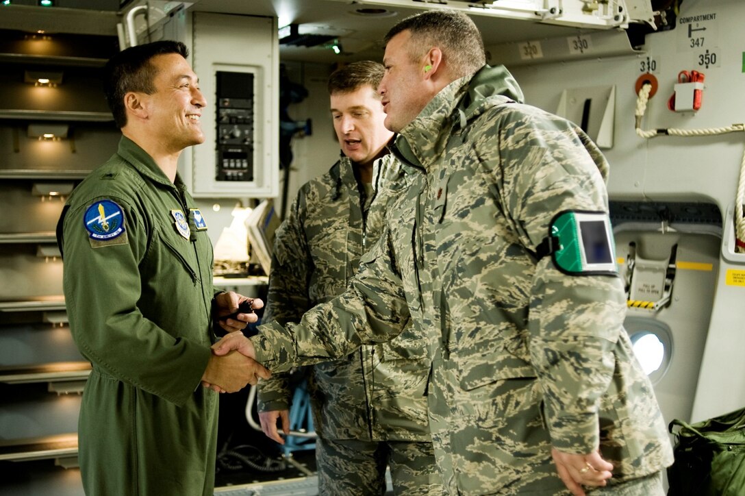 Brig. Gen. (now major general) Michael D. Kim, mobilization assistant to the Director of Operations, Headquarters Air Mobility Command, Scott Air Force Base, Ill., left, greets Maj. Christopher May, 62nd Aircraft Maintenance Squadron commander, upon arriving at McChord Field.  (U.S. Air Force File Photo/Abner Guzman)