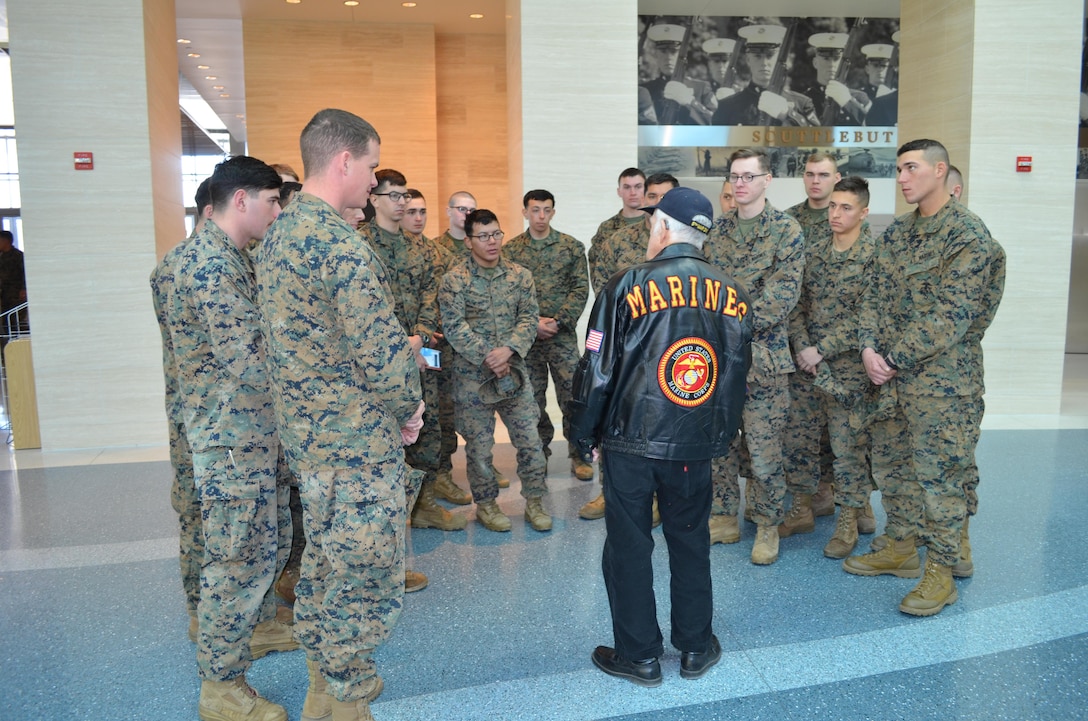 Twenty-five Marines listen as Iwo Jima veteran, George Cattelona, recounts that famous battle and offers advice during a visit to the National Museum of the Marine Corps on Friday. Cattelona was among the 18 Marine veterans and their families to visit the NMMC as part of the 70th anniversary festivities commemorating the start of the Battle of Iwo Jima.