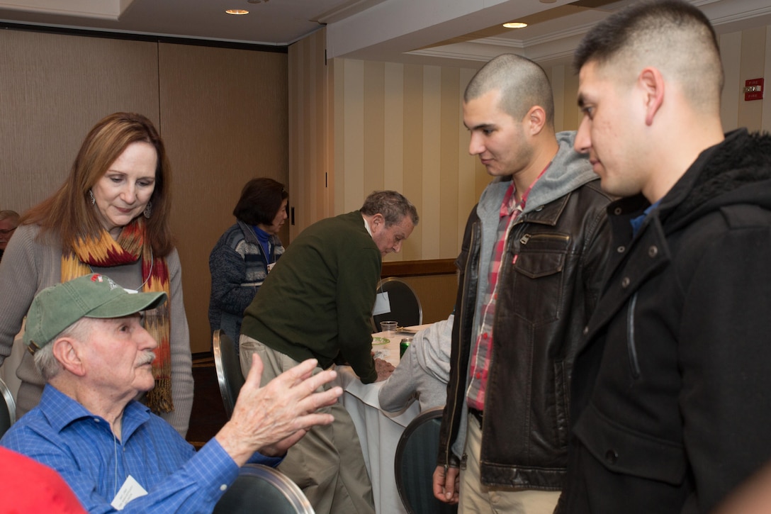 Marines from Marine Barracks Washington, D.C., converse with an Iwo Jima Veteran during an icebreaker in Arlington, Va. Feb. 18, 2015 (U.S. Marine Corps photo by Lance Cpl. Christian Varney/Released)