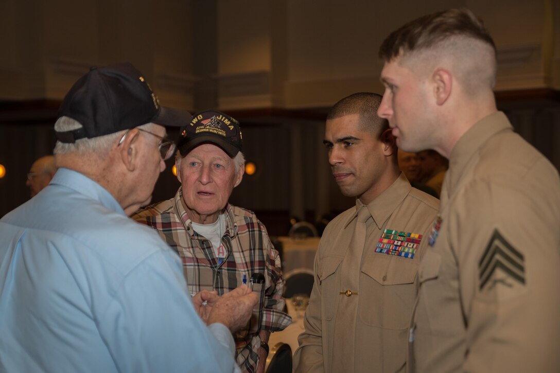 Marines from Marine Barracks Washington, D.C., converse with Iwo Jima Veterans after a lecture series in Arlington, Va. Feb. 21, 2015. (U.S. Marine Corps photo by Lance Cpl. Christian Varney/Released)