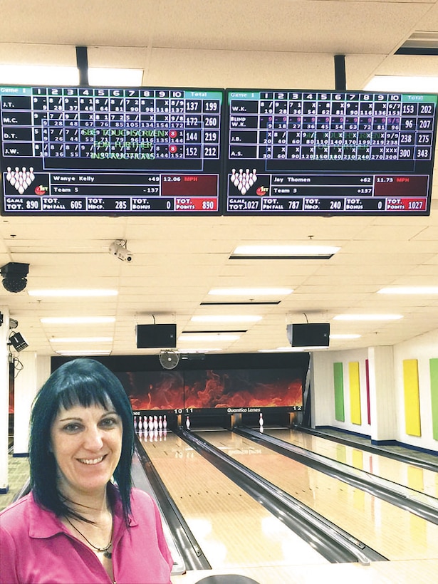 Andrea Sharp poses with her perfect score tallied on the scoreboard on Feb. 19 at the Quantico Bowling Center at Little Hall.