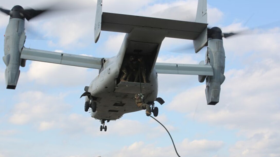 A Marine uses his newly learned helicopter rope suspension techniques while fast roping out of an MV-22B Osprey during a Fast Rope Operator Course training exercise at Stone Bay aboard Camp Lejeune, N.C., Feb. 5, 2015. Helicopters cannot always land in a landing zone and the squad must fast rope into an LZ in order to conduct operations in the area. The Fast-Rope Operators Course is a one week course that teaches Marines these needed techniques.