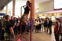 Sgt. Richard Skates, a recruiter with Marine Corps Recruiting Station Twin Cities, motivates a wrestler conducting pull ups with the United States Marines, before his competition during the Minnesota High School Wrestling Tournament held at the Excel Energy Center, February 26. 