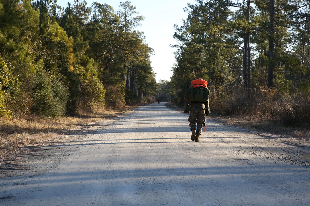 Marines perform a weighted pack run during Phase I of the U.S. Marine Corps Forces Special Operations Command's Assessment and Selection course aboard Marine Corps Base Camp Lejeune, N.C., Jan 28, 2015. Marines are required to perform several weighted pack runs varying between eight to 12 miles during the course.