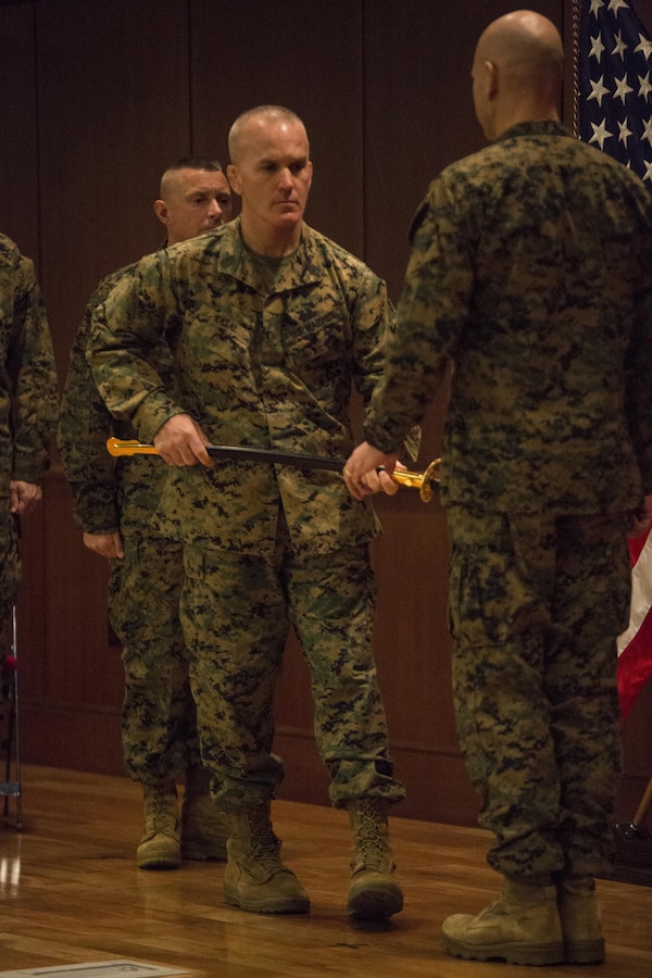 Sergeant Maj. Bradley Kasal, 4th Marine Division sergeant major,  returns the noncommissioned officer’s sword to Major Gen. Paul W. Brier, 4th MarDiv commanding general, signifying the end of his tour as 4th MarDiv sergeant major, during a relief and appointment ceremony at Marine Corps support facility New Orleans, Feb. 26, 2015. During the ceremony, the Marines bid farewell to Kasal as he prepares to assume his new post as the I Marine Expeditionary Force Sergeant Major and welcomed Sergeant Maj. Daniel Fliegel as the new sergeant major of 4th MarDiv.