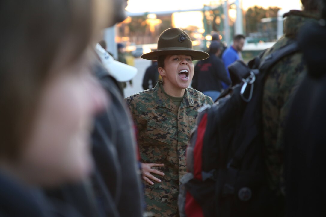 Staff Sgt. Carolin Chavez, a drill instructor at Marine Corps Recruit Depot Parris Island, South Carolina, motivates a group of educators to get into formation during the 2015 Educator Workshop, Feb 11, 2015. Educator Workshops are conducted annually by Marine recruiting stations across the United States as outreach programs to high schools within their area with the goal of showing educators how the Marine Corps can be a possible career path for their students. (U.S. Marine Corps photo by Cpl. Tyler Birky/Released)