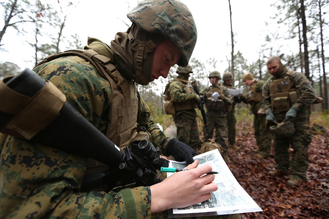 Private First Class Clayton Bolen, a combat engineer with 8th Engineer Support Battalion, plots points on a map before executing a patrolling exercise aboard Marine Corps Base Camp Lejeune, N.C. Feb. 26, 2015. The patrolling exercise gave the unit a sense of their proficiency level and how it can be improved in the future.