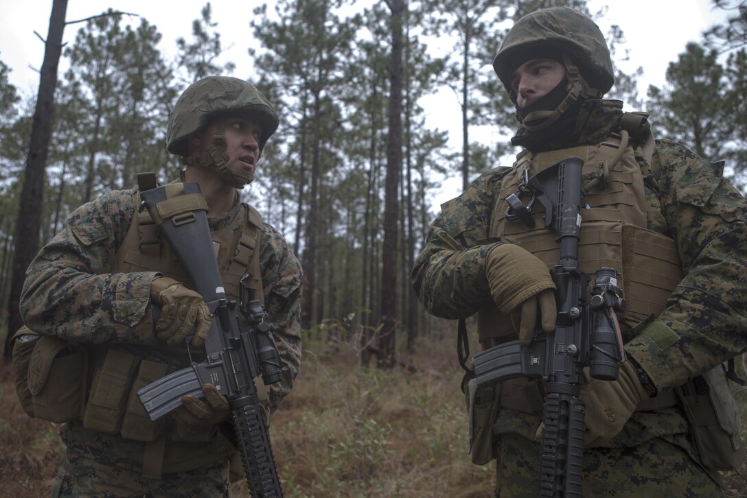 Cpl. Matthew Tarum (left), a squad leader with 8th Engineer Support Battalion and Lance Cpl. Adam Thomas, a combat engineer with 8th ESB, discuss the squad's next movement during a patrolling exercise aboard Marine Corps Base Camp Lejeune, N.C., Feb. 26, 2015. The patrolling exercise gave the unit a sense of their proficiency level and how it can be improved in the future.