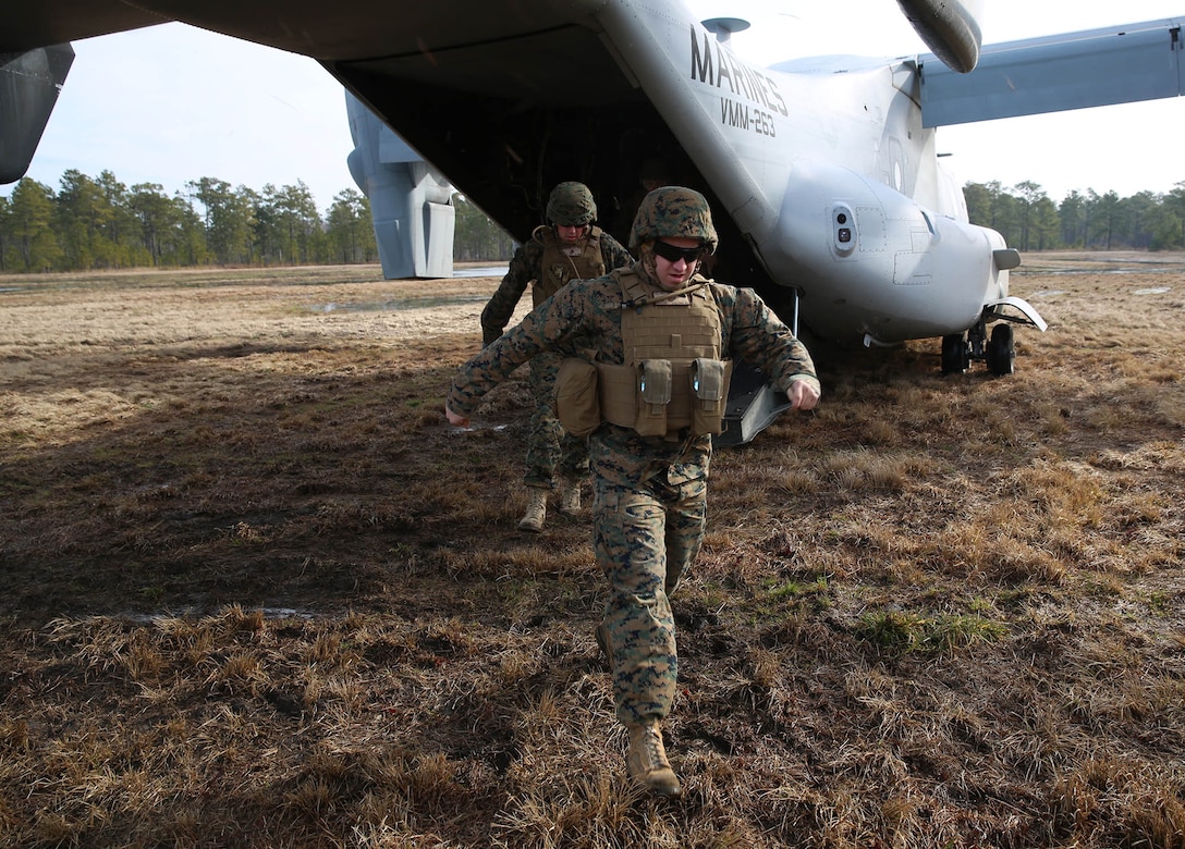 U.S. Marines with the 22nd Marine Expeditionary Unit exit an MV-22 Osprey aircraft at Marine Corps Base Camp Lejeune, N.C., Feb. 27, 2015. The unit conducted a seven-mile hike to maintain unit readiness and build morale. (U.S. Marine Corps photo by Cpl. Caleb McDonald/Released)