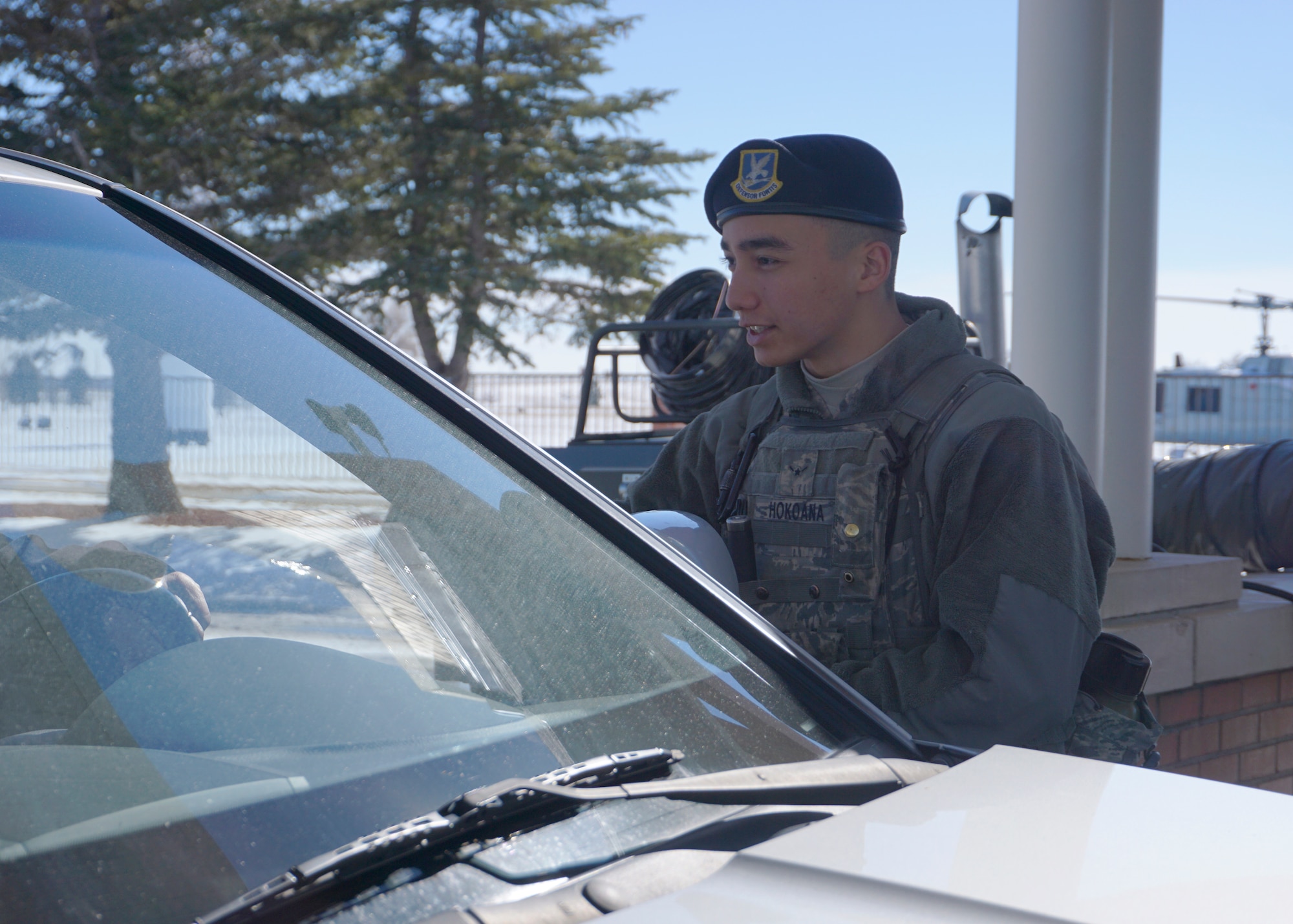 Airman Kaiea Hokoana, 90th Security Forces Squadron, conducts a routine I.D. check at the front gate on F.E. Warren Air Force Base, Wyo., Feb. 23, 2015. Hokoana provides safety and security for the base population as a gate guard. (U.S. Air Force photo by Lan Kim)
