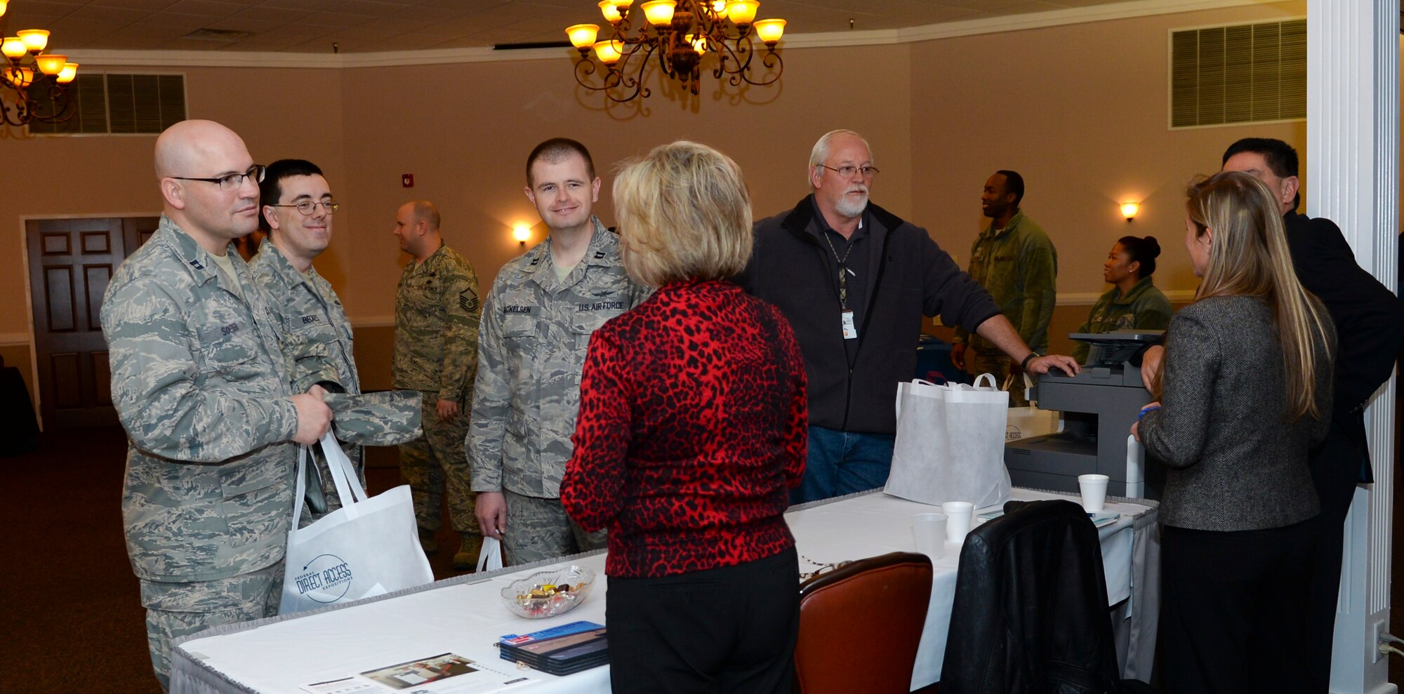 Attendees talk to vendors during the 2015 Technology Expo on Barksdale Air Force Base, La., Feb. 26, 2015. Guests were given bags to collect pamphlets, samples and other marketing items. (U.S. Air Force photo/Senior Airman Benjamin Raughton)