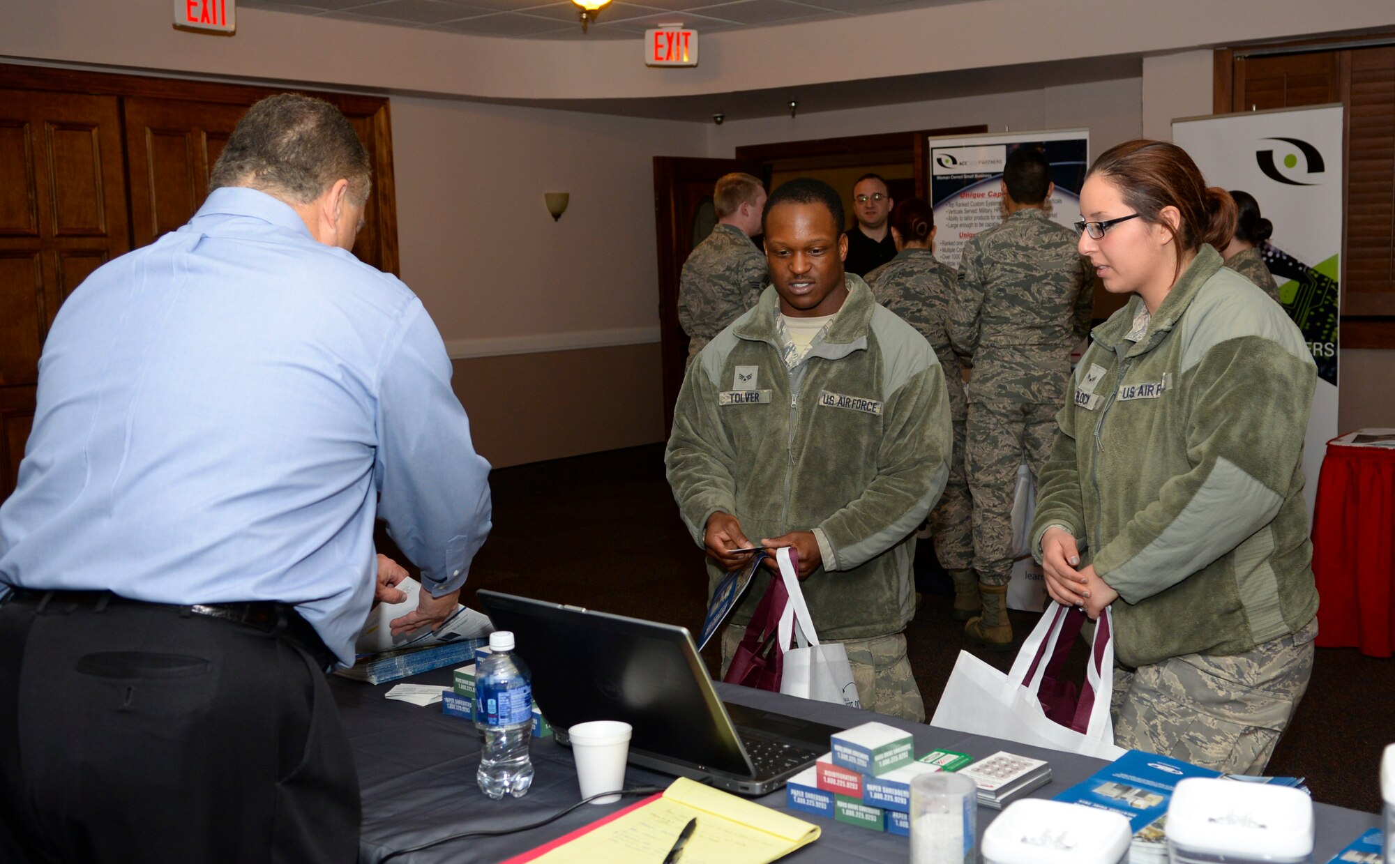 Senior Airman Tevin Tolver, left, and Airman 1st Class Noor Block, 2nd Civil Engineer Squadron, speak to a vendor at the 2015 Technology Expo on Barksdale Air Force Base, La., Feb. 26, 2015. The vendor described paper and CD shredding devices being offered to the military. (U.S. Air Force photo/Senior Airman Benjamin Raughton)
