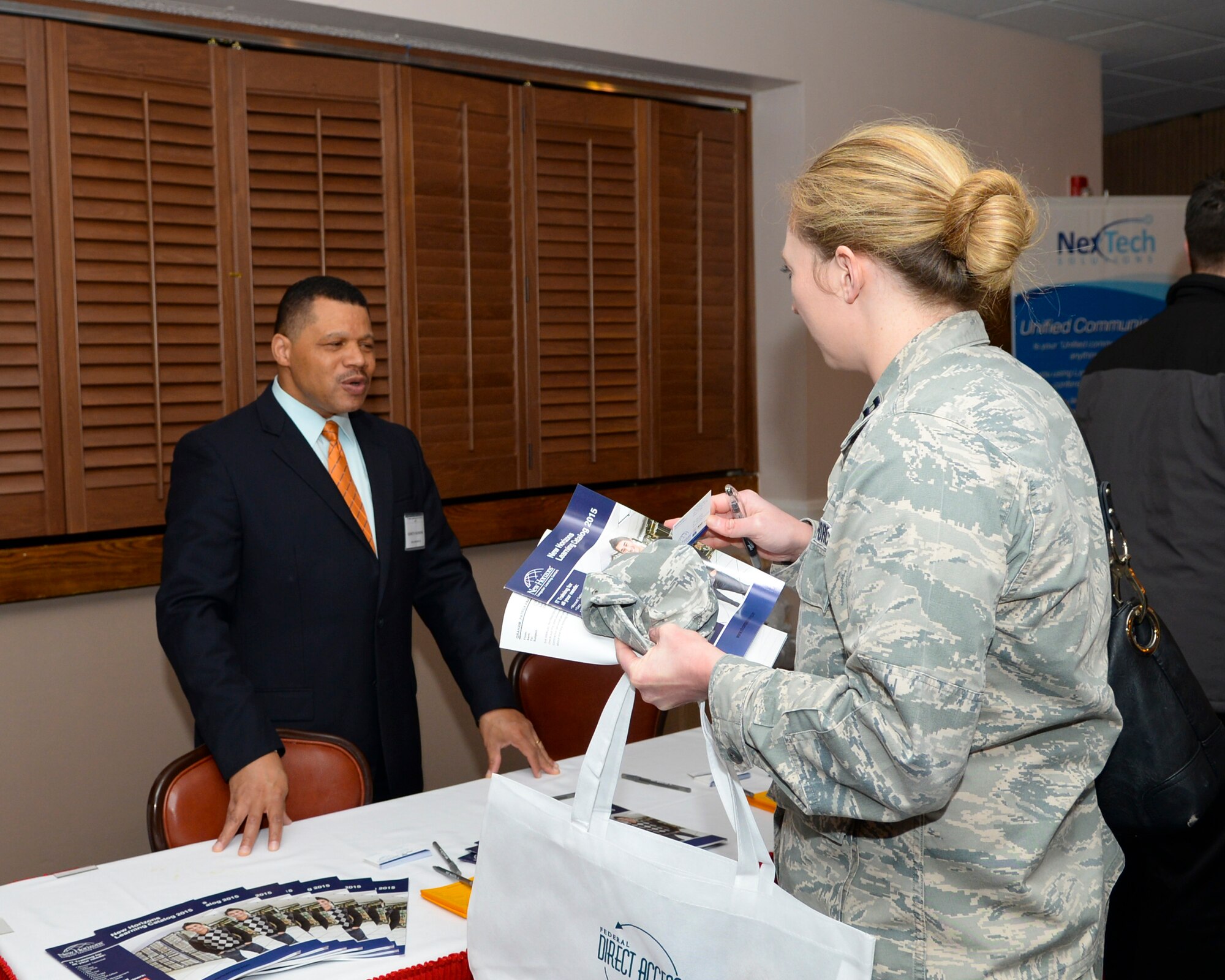 Capt. Jenny Walk, Air Force installation contracting specialist, talks to a vendor during the 2015 Technology Expo on Barksdale Air Force Base, La., Feb. 26, 2015. In addition to offering the latest technological gadgets, vendors also offer information technology training. (U.S. Air Force photo/Senior Airman Benjamin Raughton)