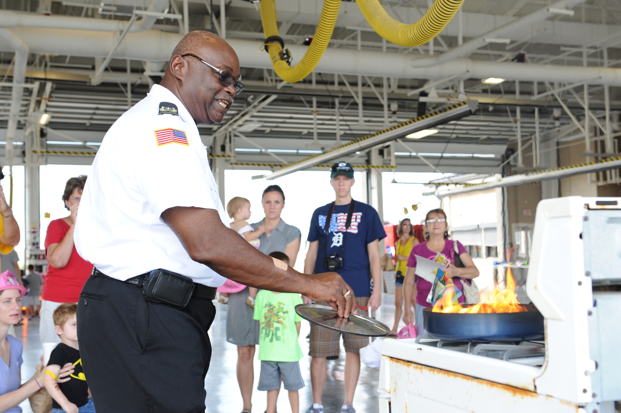 James Palmer, Keesler Fire Prevention assistant chief, gives a stove fire demonstration during the fire department open house Oct. 12, 2013, Keesler Air Force Base, Miss. The open house offered tours, fire truck rides, displays, games and fire safety handouts. (U.S. Air Force photo by Airman 1st Class Stephan Coleman)